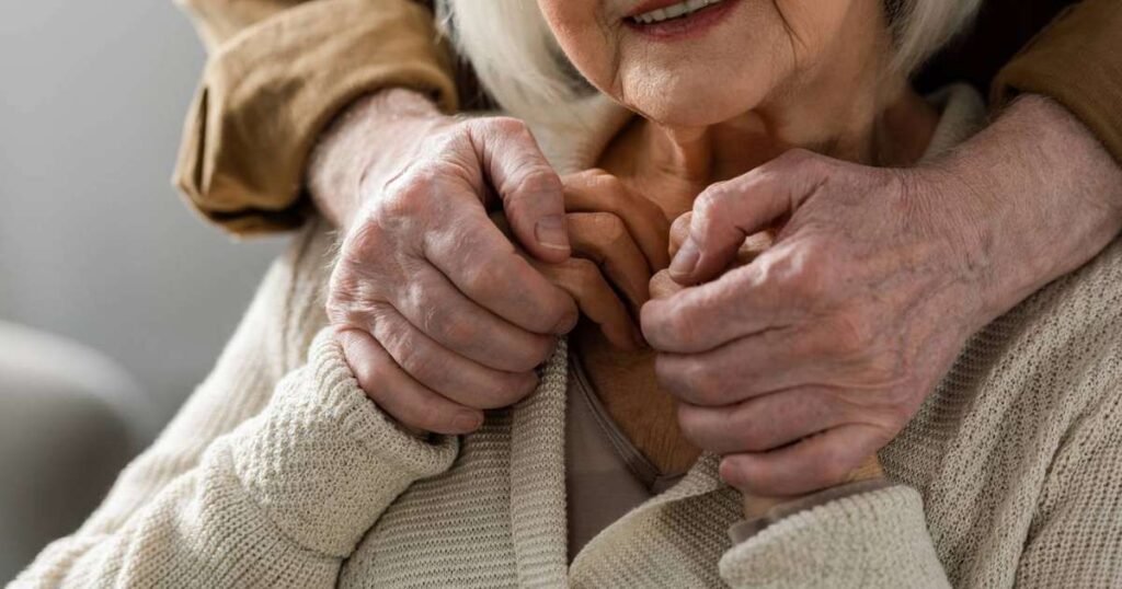 Pessoa idosa sorrindo em um parque, simbolizando felicidade e bem-estar na velhice
