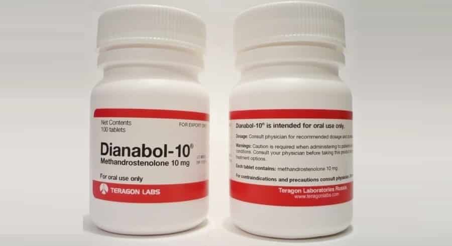 Uma lâmina do esteroide anabólico Dianabol com comprimidos e uma fita métrica ao fundo